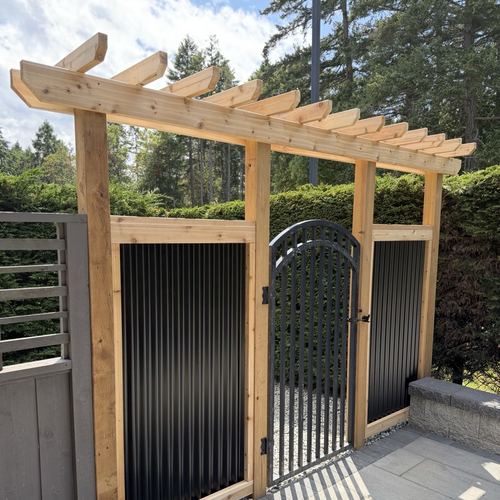 Pedestrian gate with cedar frame and black metal panels