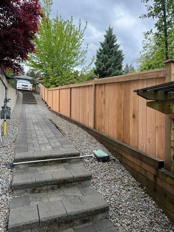 Cedar fence running alongside a gravel path