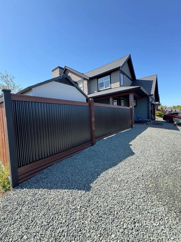 Black metal fence and gate at a modern Vancouver Island home
