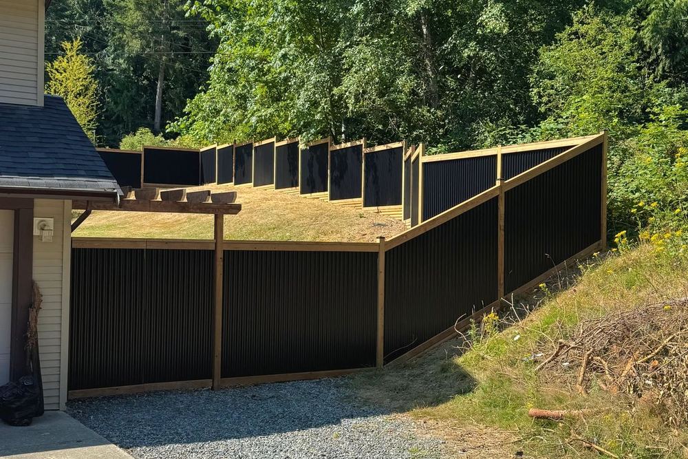 Cedar and metal fence line built by Tonella Contracting in Nanaimo